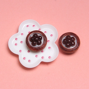 Close-up of vintage flower-patterned brown buttons on a small white decorative plate