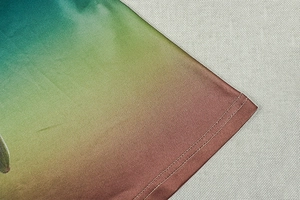 Detail of three-color gradient fabric with double-needle stitching and glossy texture