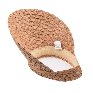 Detailed view of brown straw sun hat interior with inner sweatband and wavy brim edge