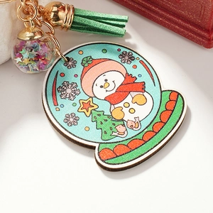 Christmas snowman wooden keychain featuring a colorful glitter ball and green tassel