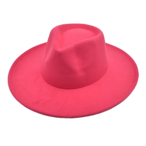 Detailed close-up of vibrant rose red wool felt fedora with classic teardrop crown shape