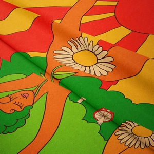 Close-up of vibrant bohemian tapestry texture with colorful sun and floral motifs