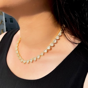 Close-up of a gold-plated Cuban link heart necklace with micro-pave cubic zirconia
