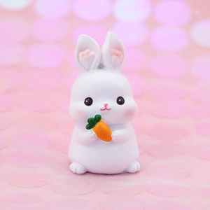 Cute white cartoon rabbit figurine holding a carrot for car interior or cake decoration