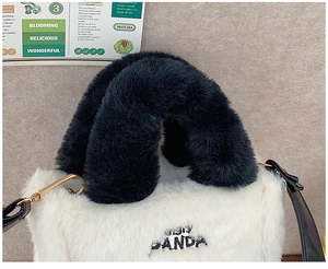 Close-up of black and white faux fur panda handbag with panda embroidery and gold hardware