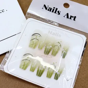 Faux ongles faits main dégradé vert clair avec motifs de feuilles et accents de perles