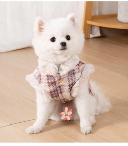 Detail of warm pink plaid pet vest with faux fur collar and metal buttons for small dogs