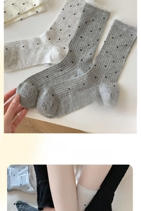Detail of ribbed bamboo fiber socks featuring polka dots and elastic ruffled lace cuffs