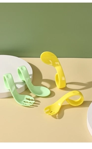 Detail of ergonomic ring-handle training fork and spoon set for toddler self-feeding