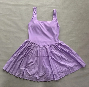 Detailed flat lay of light purple tennis dress featuring pleated hem and wide straps