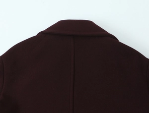 Detail of the high-quality dark wine red wool blend fabric on the back and collar of the coat