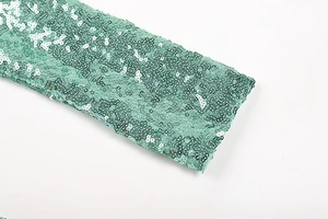 Detailed macro shot of mint green sequin fabric with high-quality reflective texture