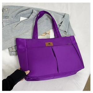 Detailed top view of a purple waterproof nylon tote bag with dual front pockets