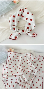 Detailed view of white scarf with red polka dots in tied bow and flat layout styles