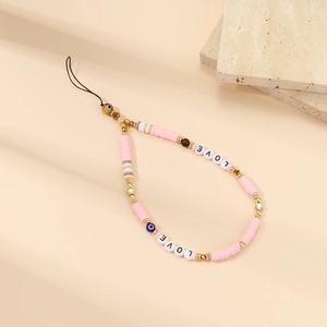 Detail of handmade beaded phone strap with pink clay discs, evil eye, and LOVE letter beads