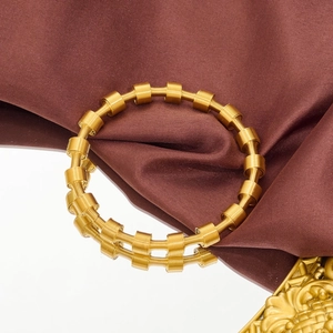 Detailed macro view of the golden spring coil structure and cylindrical metal accents