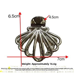 Macro view showing dimensions of silver fan-shaped metal hair claw clip with shell texture