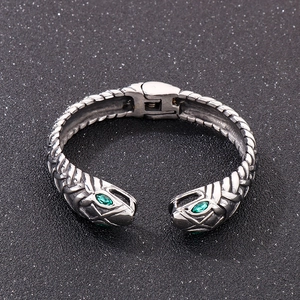 Detail of snake scale texture and green zircon eyes on antique silver steel bracelet