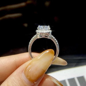 Macro close-up of S925 silver moissanite ring with square-cut stone and diamond halo detail