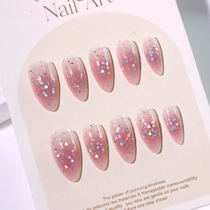 Short almond press-on nails featuring pink gradient glitter and laser heart sequins