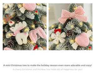 Detail of mini flocked Christmas tree with pink ornaments and warm festive lights