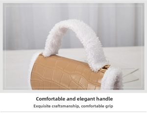 Close-up of tan crocodile embossed leather handbag with soft white fleece handle