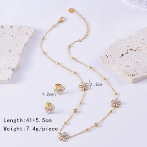 Detail view of gold flower necklace and earrings set with zircon stones and dimensions