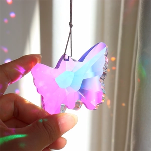 Crystal butterfly prism suncatcher showing vibrant rainbow reflections in hand