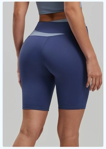 Close-up of high-elasticity contrast patchwork waistband on slim-fit yoga shorts for women