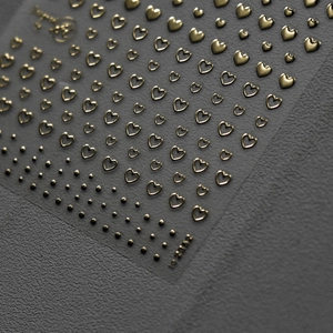 3D embossed gold heart nail art stickers with metallic texture and minimalist star patterns