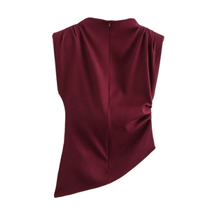 Close-up of burgundy sleeveless top with back zipper and draped pleated details