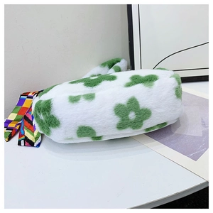 Close-up of fluffy white faux fur handbag with green flower pattern and decorative scarf