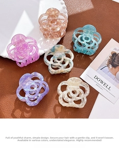 Close-up of hollowed camellia flower acetate hair claws in various vibrant colors