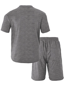Detail of dark grey men's polo set showing breathable waffle knit texture and fabric finish