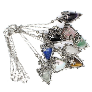 Detail of assorted cone-shaped crystal pendants with intricate silver wire wrap designs