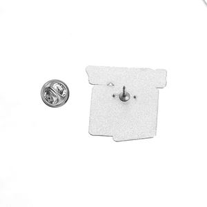 Close-up of the metal lapel pin back showing square zinc alloy base and butterfly clutch