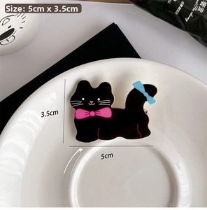 Polka dot cat hair clip in black acrylic showing 5cm length and 3.5cm width dimensions