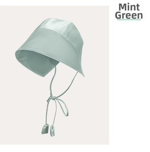 Detail of mint green silk sun hat featuring long ribbons and smooth satin fabric texture
