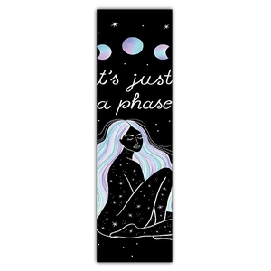 Detail of black bookmark featuring moon phases, starlight woman and text it's just a phase