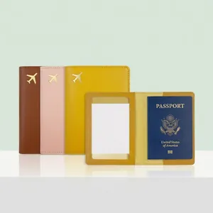 Detail of PU leather passport holder with gold airplane motif and internal clear card slot