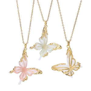 Three gold butterfly necklaces featuring pink and white shells with one hollowed pendant