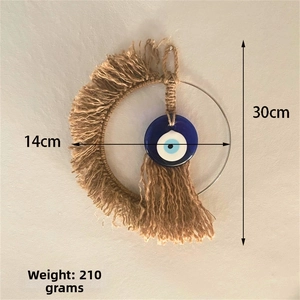 Detailed view of woven moon evil eye wall hanging with 14cm width and 30cm height dimensions