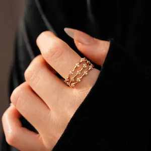 Three-layer gold bamboo joint rings with zircon accents in a stacked minimalist style