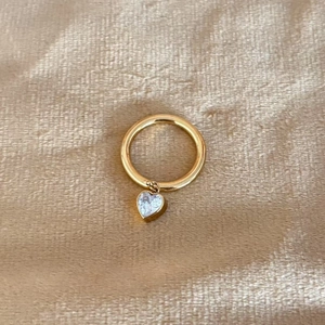 Exquisite gold stainless steel ring featuring a micro-pave zircon heart pendant on gold silk