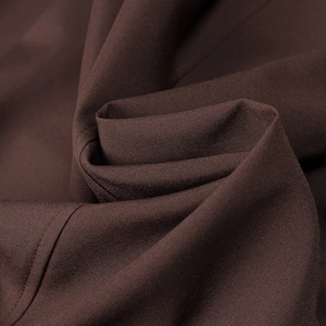 Close-up of high-quality dark brown woven fabric with detailed stitching and twill texture