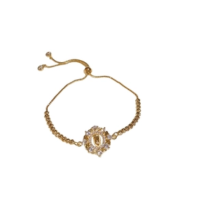 Adjustable gold bracelet featuring sparkling zircon stones and a classic portrait pendant