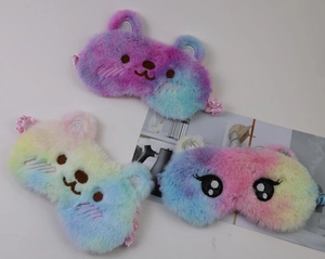 Detailed view of colorful plush animal sleep masks with rainbow gradient and soft texture
