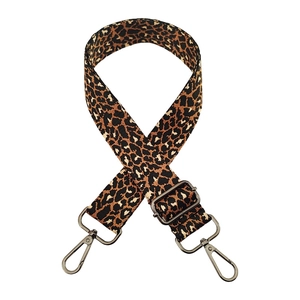 Macro shot of jacquard leopard print bag strap with durable metal hooks and buckle