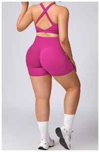 Detail of rose purple yoga set featuring cross-back sports bra and high waist shorts