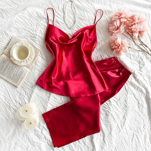 Elegant red silk satin pajama set with camisole and long pants on white background